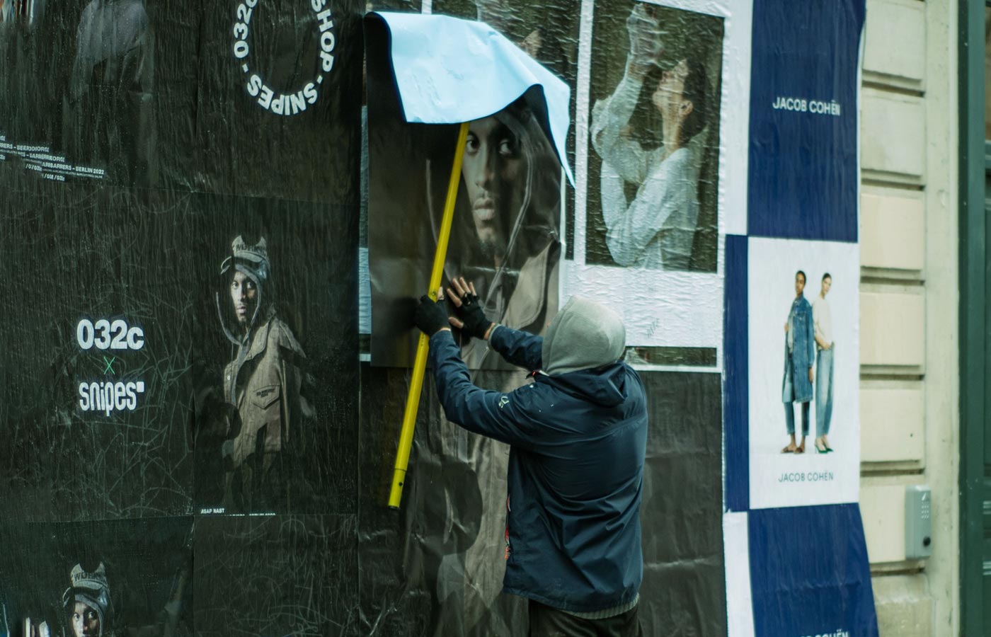 Wheatpaste poster installation by street teams in Seattle